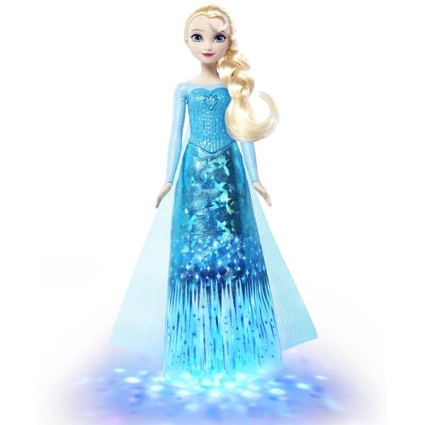 Papusa Elsa din Disney Frozen aduce magia Regatului de Gheata intr-o versiune interactiva cu muzica si efecte luminoase Prin apasarea zonei indicate pe piept papusa activeaza o melodie si lumini care pun in valoare tinuta inspirata de personajul Elsa Papusa poarta o rochie eleganta in nuante de albastru cu detalii stralucitoare si motive inspirate de gheata si fulgi de zapada Parul blond impletit lateral completeaza aspectul emblematic al personajului Este potrivita pentru recrearea 