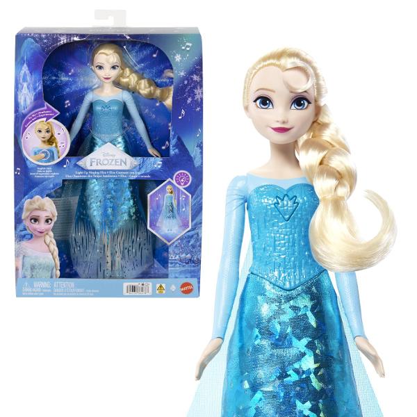 Papusa Elsa din Disney Frozen aduce magia Regatului de Gheata intr-o versiune interactiva cu muzica si efecte luminoase Prin apasarea zonei indicate pe piept papusa activeaza o melodie si lumini care pun in valoare tinuta inspirata de personajul Elsa Papusa poarta o rochie eleganta in nuante de albastru cu detalii stralucitoare si motive inspirate de gheata si fulgi de zapada Parul blond impletit lateral completeaza aspectul emblematic al personajului Este potrivita pentru recrearea 